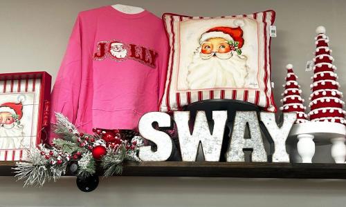 Jolly Sweater and Santa Themed Christmas display at Sway Boutique.