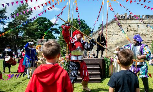 Colourful bunting and costumed characters at Warwick Castle