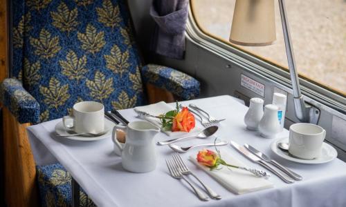 Afternoon tea for two people laid out on a table on a train