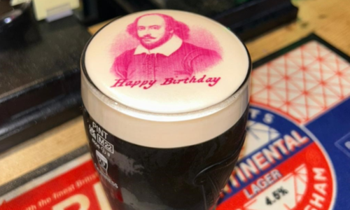 A picture of Shakespeare on top of a pint