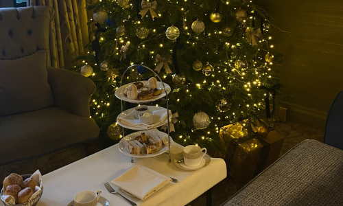 Festive afternoon tea in front of a Christmas Tree