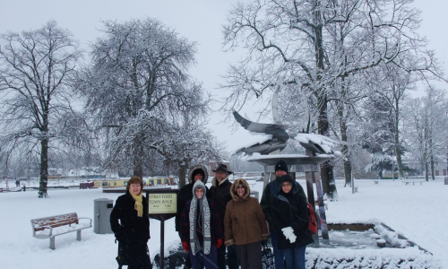 A group of people stood in the snow