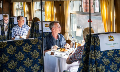 Couples dining on a vintage steam train