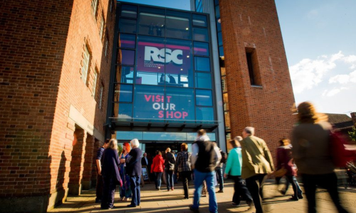 A group of people walking into the RSC in Stratford-upon-Avon