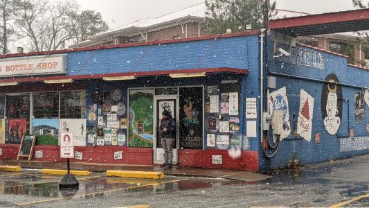 The front of Five Points Bottle Shop is shown on a snowy day.