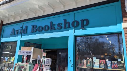 The blue shopfront of Avid Bookshop is shown.