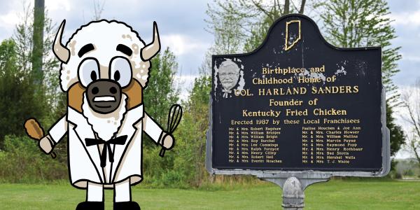 Colonel Harland David Sanders historical marker in Henryville, IN, with cartoon mascot Billie the Bison.