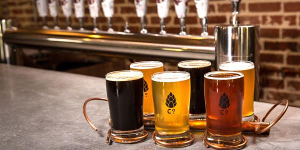 Six beers of various styles in front of the tap at Goshen Brewing Company