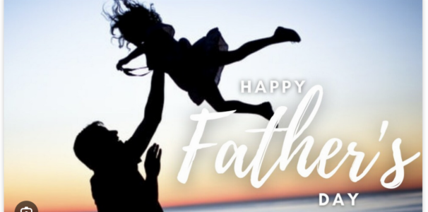 Silhouetted father tossing little girl in the air