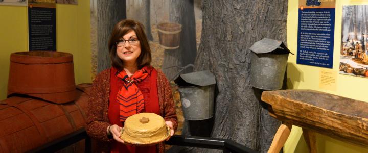 Woman holding a burnt sugar cake