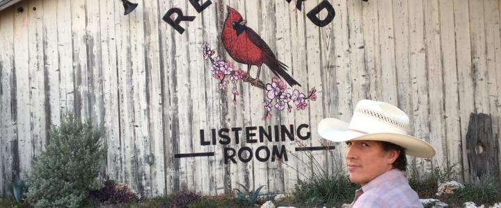 Man sitting on bench outside of the Redbird Listening Room