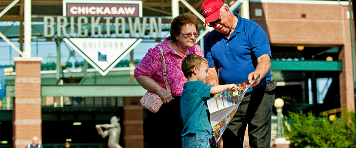 Family in front of Chickasaw Bricktown Ballpark in Bricktown