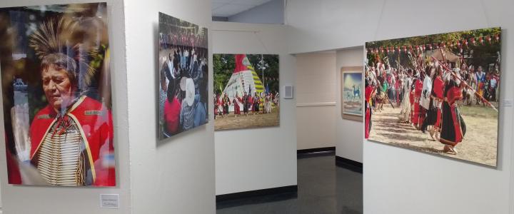 Photography and paintings hanging in the Red Earth Art Center