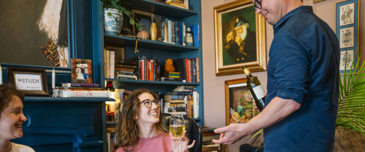 Two young women being served wine at The Study