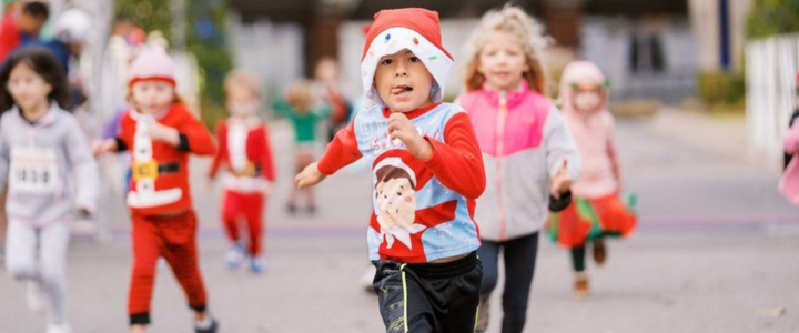 A little boy running the Kids' Dash at the Saints Santa Run