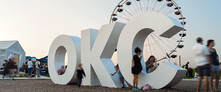 People In front of OKC Sign at the Wheeler District