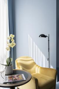 a yellow accessible chair in the bedroom of the Hyatt Centric Cambridge