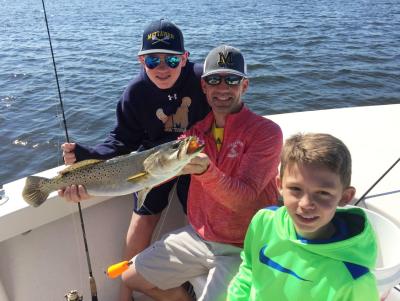 Fun family fishing: showing off a speckled trout caught in Punta Gorda/Englewood Beach
