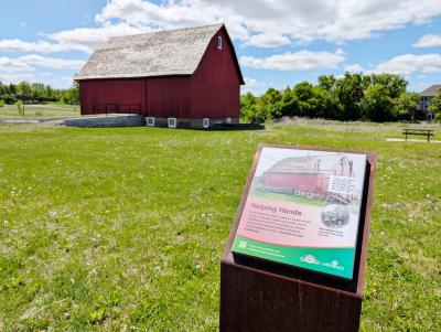 Historic red barn with self-guided tour signage