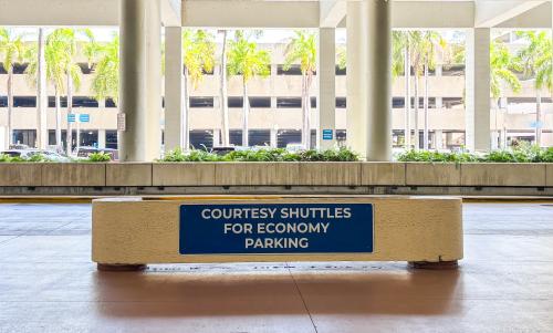 Courtesy Shuttles for Economy Parking sign.