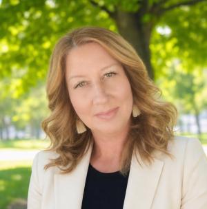headshot of a lady in front of a tree