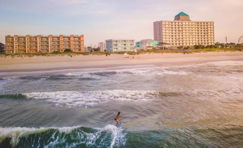 Woman surfing alone at Carolina Beach, NC