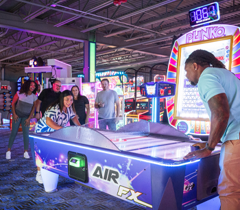 Group playing air hockey