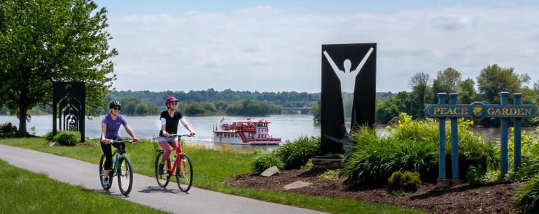 Biking Riverfront Park w Riverboat Background