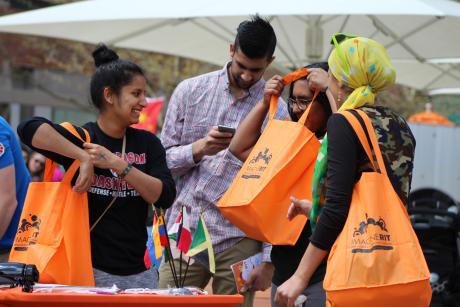 Visitors get their swag bags for all the Imagine RIT goodies