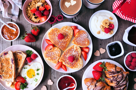 heart shaped pancakes, various breakfast foods, hearts, and strawberries