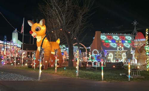Rudolph inflatable decoration with Christmas lights lighting up the area