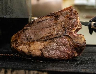 A steak is grilled on its side at Doe's Eat Place, Fort Smith, Arkansas