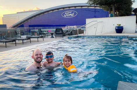 Father, son, and daughter swimming at Omni Frisco Hotel pool