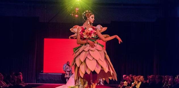 Model with fairy dress with pink petals and pink wings on stage