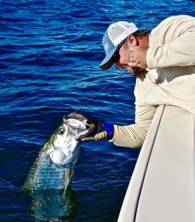 Capt. Jay Withers reels in a tarpon