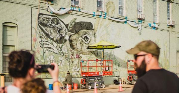 Artist working on mural