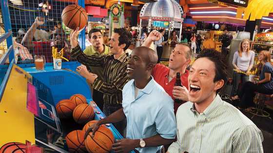 Guys playing pop a shot basketball