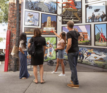 Group of four looking at Ann Arbor Murals