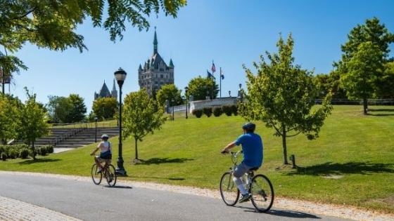 Two people ride bikes on the Empire State Trail at the Corning Preserve