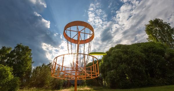A frisbee flying into a disc golf goal