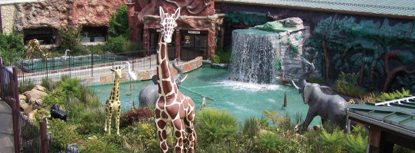 Image of the front water fountain of Jungle Jim's which features an elephant, girrafe and waterfall.