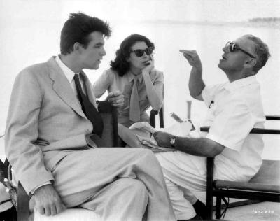 Bill Travers and Ava Gardner sitting on set with and listening to George Cukor, director of Bhowani Junction