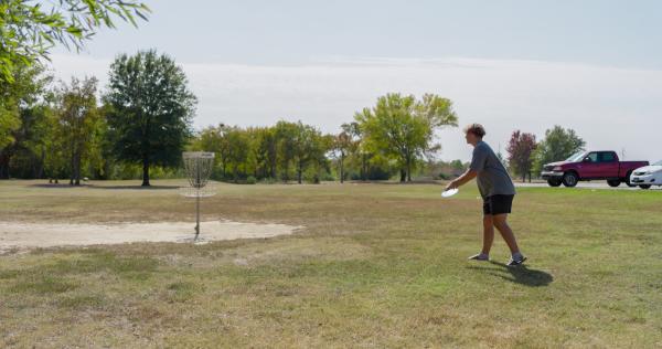 A teen prepares to make a throw while playing disc golf at Ben Garen Park, Fort Smith, Arkansas.