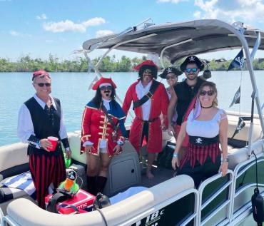 "Pirates" having fun on a boat for the Pirate Poker Run, an aspect of Englewood Beach Waterfest that comes to Englewood in November.