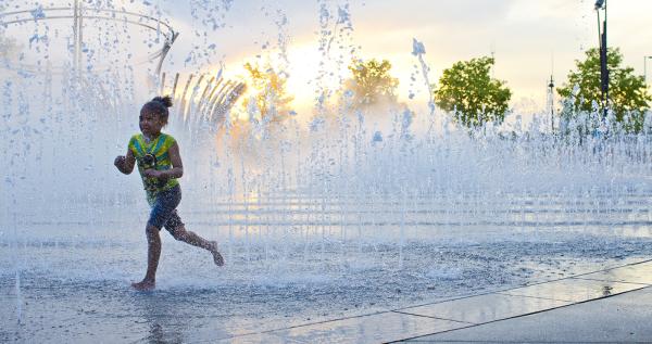 Girl running through fountains at Bicentennial Park