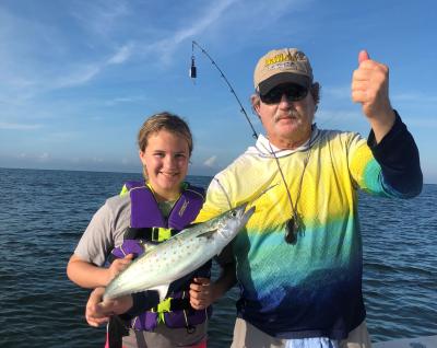 Capt. Van and child holding a freshly-caught Spanish mackerel