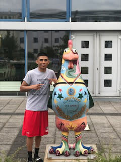Angel Martinez and chicken statue