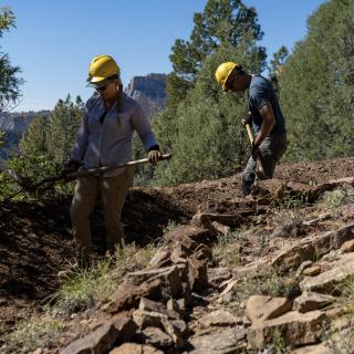 People working on trail maintenance on the Animas Mountain Trail.