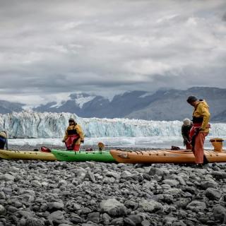 kayaks on a beach in a glacial bay