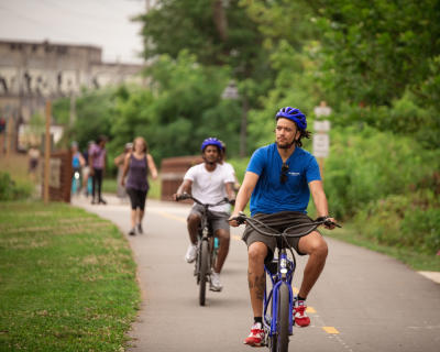 Two men riding bikes along the greenway in Asheville